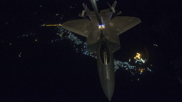 A KC-10 Extender from the 908th Expeditionary Air Refueling Squadron, Al Dhafra Air Base, United Arab Emirates, refuels an F-22 Raptor from the 95th Expeditionary Fighter Squadron in support of a new offensive campaign in Afghanistan Nov. 19, 2017. (U.S. Air Force Photo by Gregory Brook)
