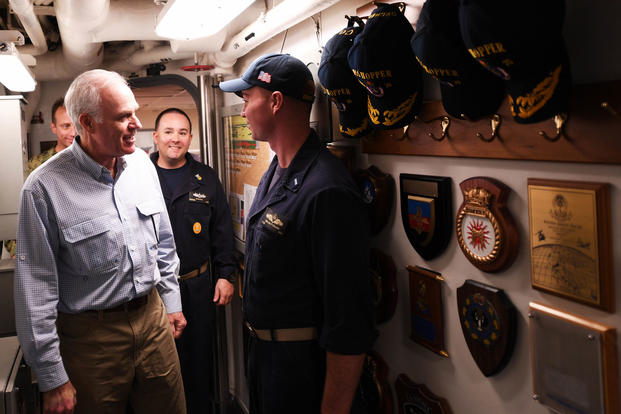 Secretary of the Navy Richard V. Spencer greets Lt. j.g. Keelen Collins, the navigator aboard the Arleigh Burke-class guided-missile destroyer USS Hopper (DDG 70), during a visit to the ship on Thanksgiving Day, Nov. 23, 2017. (U.S. Navy photo/Kristina Young)