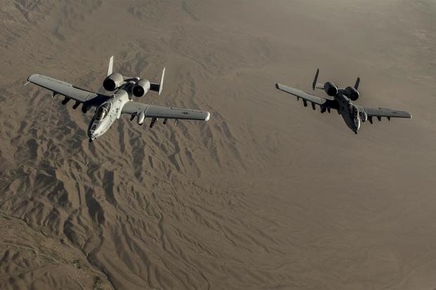 Two U.S. Air Force A-10 Thunderbolt II's with the 303rd Expeditionary Fighter Squadron fly in formation behind a KC-135 after conducting an air-to-air refueling over the skies of eastern Afghanistan, July 10, 2014. (U.S. Air Force/Senior Airman Matthew Bruch)