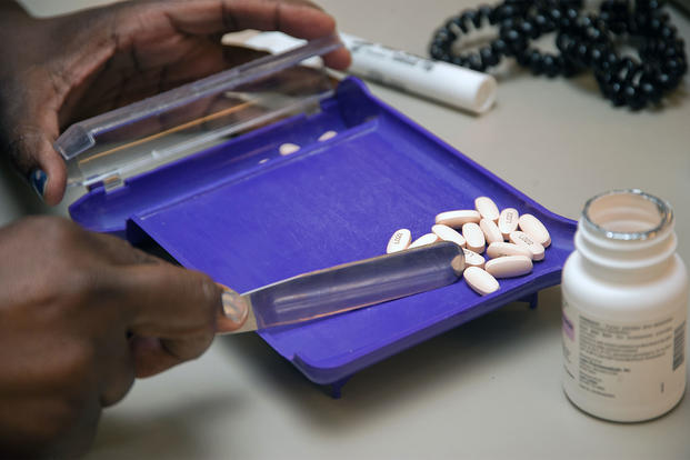 A pharmacy technician counts pills before filling a prescription. (U.S. Air Force/Bobby Jones)