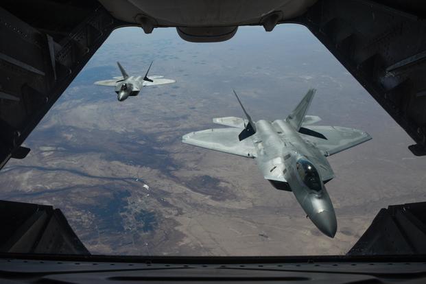 FILE -- Two U.S. Air Force F-22 Raptors fly above Syria in support of Operation Inherent Resolve, Feb. 2, 2018. (U.S. Air National Guard/Staff Sgt. Colton Elliott)