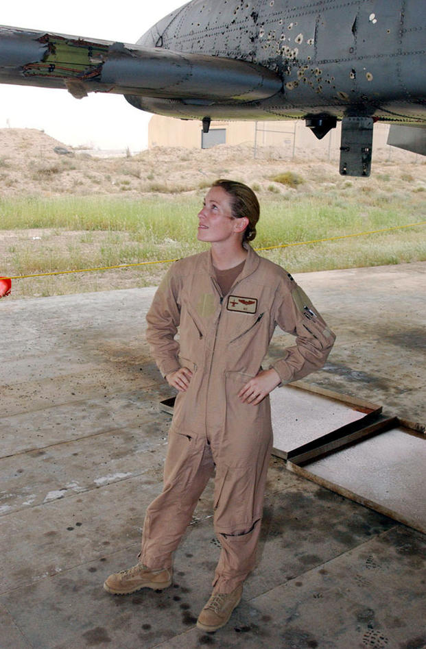 Then-Capt. Kim Campbell surveys the battle damage to her A-10 Thunderbolt II at a base in Southwest Asia. Captain Campbell's A-10 was hit over Baghdad during a close air support mission on April 7, 2003. At the time she was deployed with the 332nd Air Expeditionary Wing. (AF Courtesy Photo)