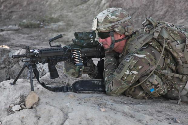 Soldier fires an M249 squad automatic weapon. (Army Photo)