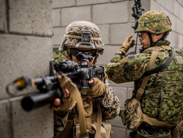 A U.S. Marine with 1st Combat Engineer Battalion and Japan Ground Self Defense Soldier with the Western Army Infantry Regiment, clear hallways while conducting Urban Explosive Demolitions training during exercise Iron Fist 2018, Jan. 19. (Robert Alejandre/Marine Corps)
