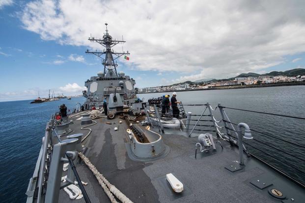 Sailors man the rails of the guided-missile destroyer USS Jason Dunham (DDG 109) as the ship departs from Ponta Delgada, Azores. (U.S. Navy/Mass Communication Specialist 3rd Class Jonathan Clay)
