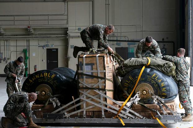 U.S. Marines with the 3d Transportation Support Battalion, secure a Helicopter Expeditionary Refueling System for air drop delivery as part of training exercise Kodiak Mace at Joint Base Elmendorf-Richardson, Alaska. (U.S. Air Force photo by Senior Airman Javier Alvarez)