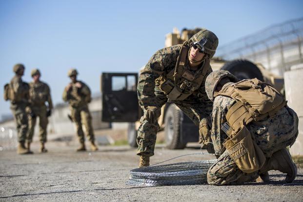 U.S. Marines with 7th Engineer Support Battalion, Special Purpose Marine Air-Ground Task Force 7, unhook concertina wire along the California-Mexico border at the Otay Mesa Port of Entry in California, Nov. 14, 2018. (U.S. Marine Corps/Sgt. Brandon Maldonado)