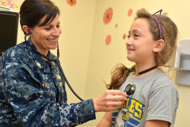 Lt. Cmdr. Michelle Finley, a nurse practitioner with Naval Branch Health Clinic Mayport’s Medical Home Port Pink Team, checks Abbigail Engle’s heart during a routine exam. (U.S. Navy/Jacob Sippel)