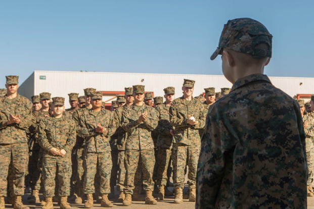 The Marines of Marine Wing Communication Squadron (MWCS) 38, 3rd Marine Aircraft Wing (MAW) applaud Alec J. Rubio, after he is appointed as an honorary Marine at Marine Corps Air Station Miramar, Calif., Dec. 19. Rubio, who was diagnosed with Adrenoleukodystrophy (ALD), a terminal illness, was awarded the title Honorary Marine by the Marines of MWCS-38, Marine Air Control Group (MACG) 38, 3rd MAW. (U.S. Marine Corps photo/Levi J. Guerra)