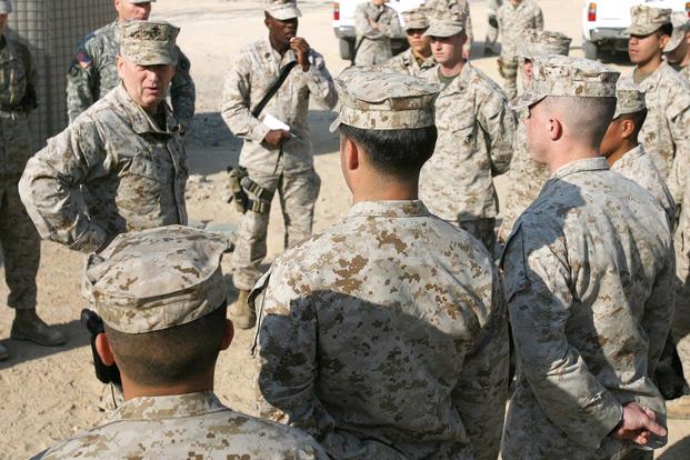 Then-Lt. Gen. Jim Mattis, head of U.S. Marine Forces Central Command and 1st Marine Expeditionary Force, speaks with Marines from Security Platoon, Headquarters and Support Company, 1st Marine Logistics Group (Forward), during a visit to Camp Taqaddum, Iraq, on Dec. 9, 2006. (U.S. Marine Corps photo by Lance Corporal Ryan L. Tomlinson)