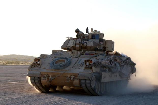 A Bradley fighting vehicle from the 3rd Infantry Division’s 2nd Armored Brigade Combat Team moves through enemy territory on the morning of May 8 before an attack on the fictional town of Razish at the National Training Center at Fort Irwin, California. Matthew Cox/Military.com