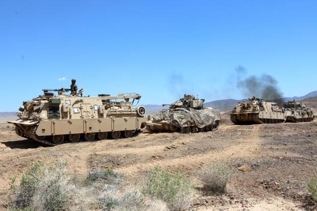 Army M88A2 Hercules recovery vehicles tow Bradley fighting vehicles belonging to the 3rd Infantry Division’s 2nd Armored Brigade Combat Team that were knocked out of action during a recent rotation at the National Training Center at Fort Irwin, California. Matthew Cox/Military.com