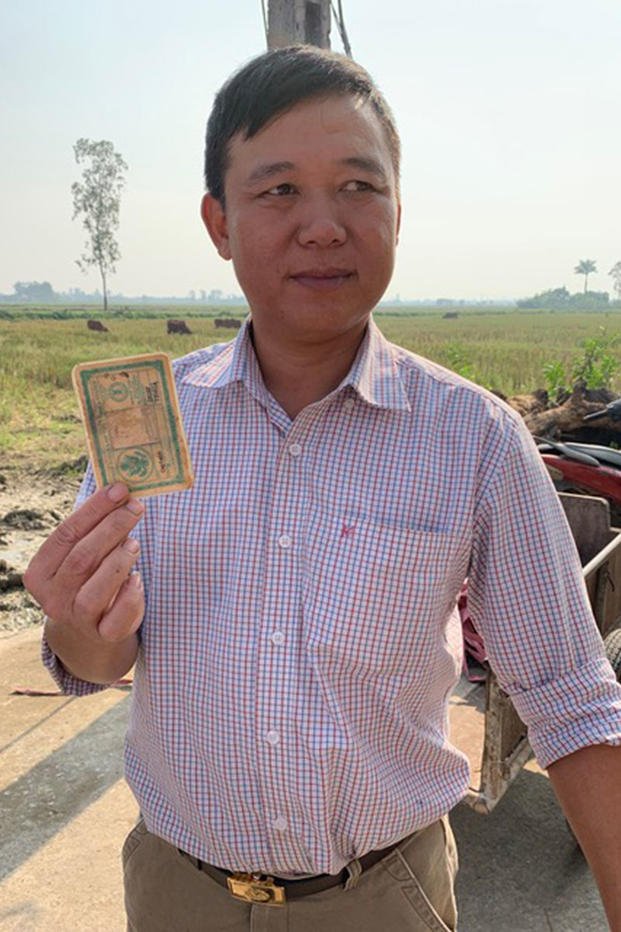  An unidentified Vietnamese man holds up the ID card of a formerly missing in action airman, Capt. Chambless Chesnutt. (Courtesy of Jill Hubbs)