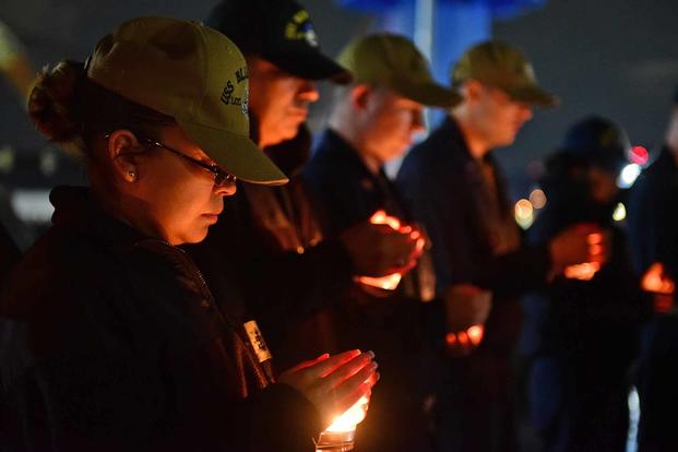Chief Religious Programs Specialist Ana Douglas, attached to U.S. 7th Fleet flagship USS Blue Ridge (LCC 19), attends a candlelight vigil in Yokosuka, Japan, in observance of Suicide Prevention month on Sept. 27, 2018. (U.S. Navy photo by Mass Communication Specialist 2nd Class Patrick Semales)