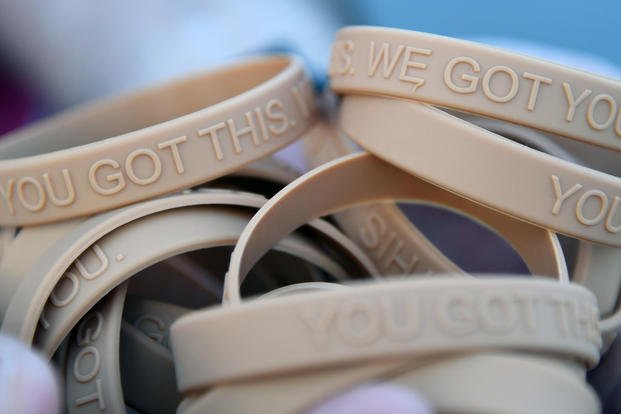Bracelets, labeled with the message, "You Got This. We Got You," are handed out to participants during the Dragon March on Keesler Air Force Base, Mississippi, Sept. 13, 2019. (U.S. Air Force/Kemberly Groue)
