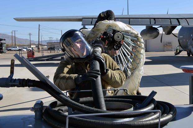 U.S. Air Force Airman 1st Class Jarrett Hoyt, 415th Aircraft Maintenance Unit hydraulics specialist, drains fuel from the inflight refueling pod on a HC-130J Combat King II on the flight line at Kirtland Air Force Base, N.M., on Nov. 14, 2019. (U.S. Air Force photo by Staff Sgt. Dylan Nuckolls)