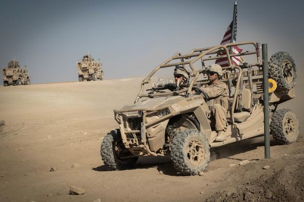 U.S. Marines drive a Utility Task Vehicle around security positions in Iraq. 