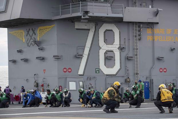 Sailors assigned to USS Gerald R. Ford's (CVN 78) air department brace for shock during a general quarters training evolution on the ship's flight deck. Ford is currently underway conducting an independent steaming exercise. (U.S. Navy photo by Mass Communication Specialist 3rd Class Connor Loessin)