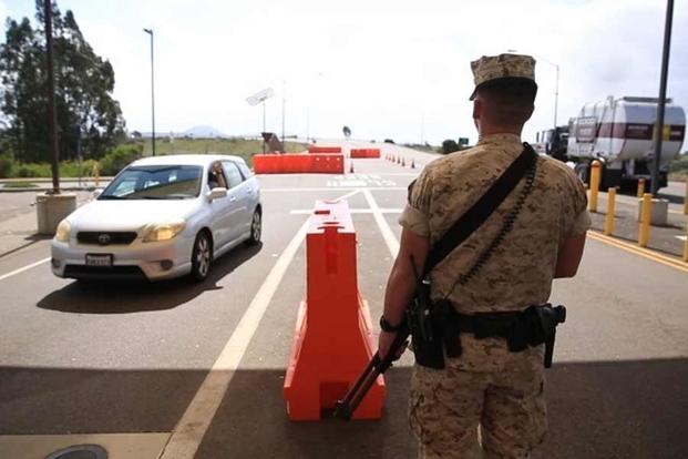 A military police officer stands guard at the east gate outside of Marine Corps Air Station Miramar, Calif., March 22, 2016. (U.S. Marine Corps/Sgt. Michael Thorn)