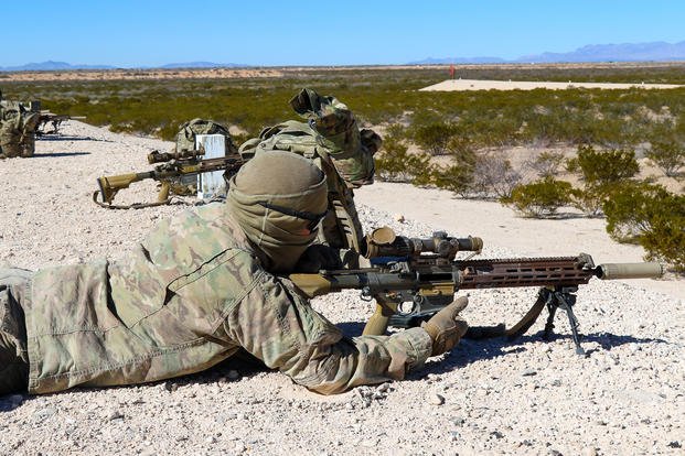 Infantry soldier fires rounds down range with the Squad Designated Marksman Rifle