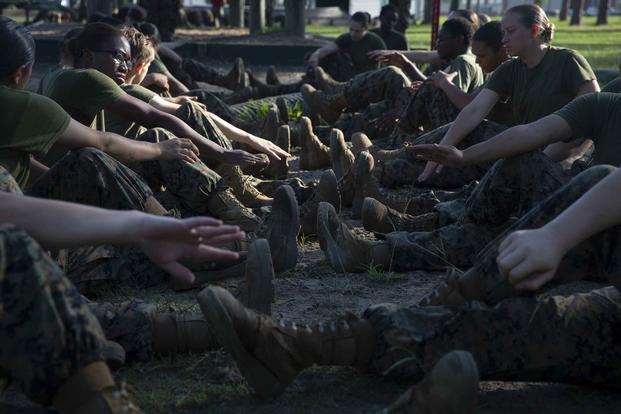 Recruits stretch between obstacles during the Confidence Course.