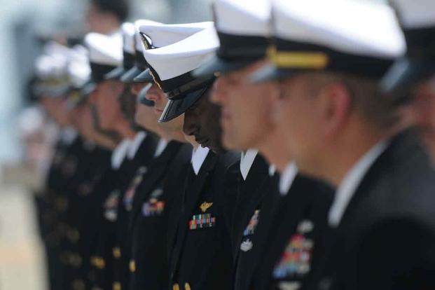 Chief petty officers assigned to the amphibious assault ship USS Essex stand in ranks.