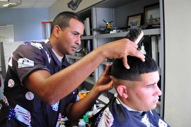 An airman cuts hair for members of the 156th Airlift Wing.