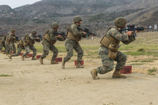 U.S. Marines assume the kneeling position before firing on static targets.