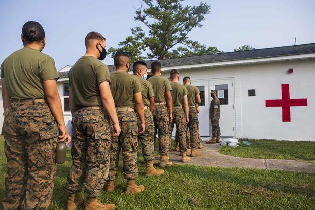 Entry-level Marines form a line for COVID-19 vaccinations at Camp Johnson