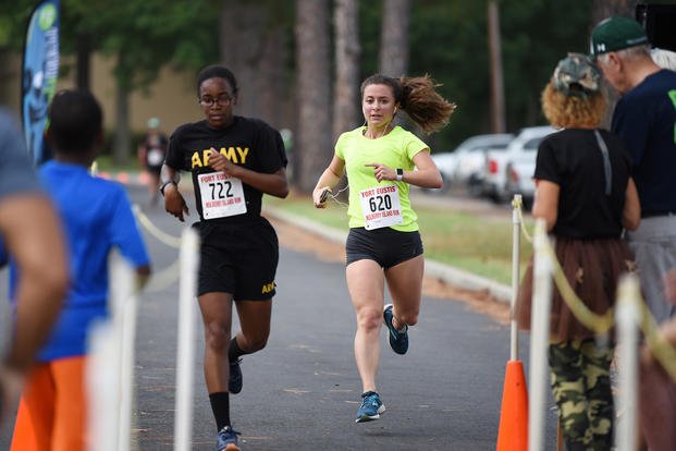 Two 38th annual Mulberry Island Half Marathon/5K race participants dash toward the finish line at Joint Base Langley-Eustis, Virginia.
