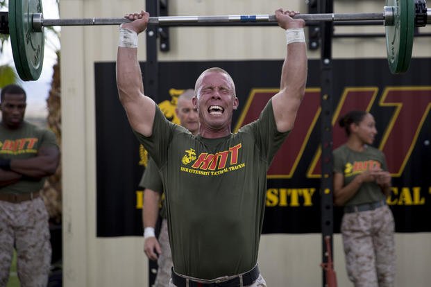Marine competes in military press.
