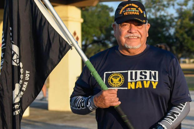 A veteran holds a POW/MIA flag 
