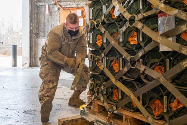 Airman palletizes ammunition, weapons and equipment bound for Ukraine