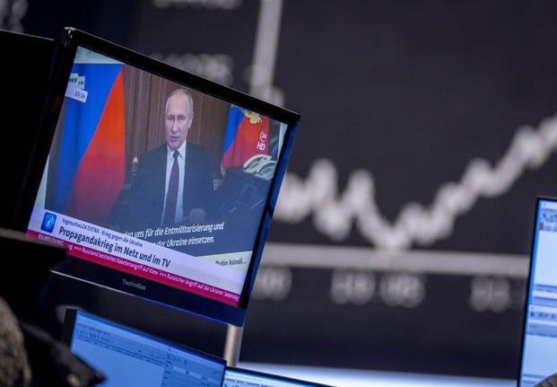 Russia's President Vladimir Putin appears on a television screen.