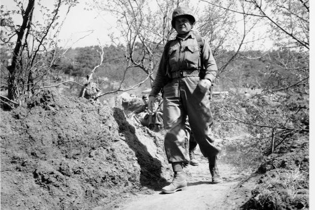 U.S. Marine Brig. Gen. Lewis B. "Chesty" Puller strides along a narrow trail in the battle area during the Korean War on May 12, 1951.
