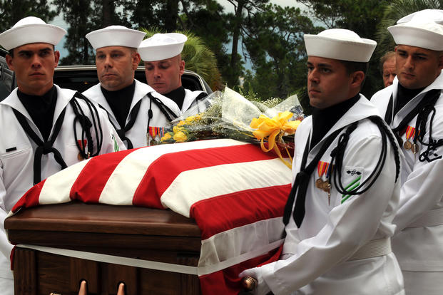 Members of a Navy honor guard carry the remains of Capt. Michael ‘Scott’ Speicher.