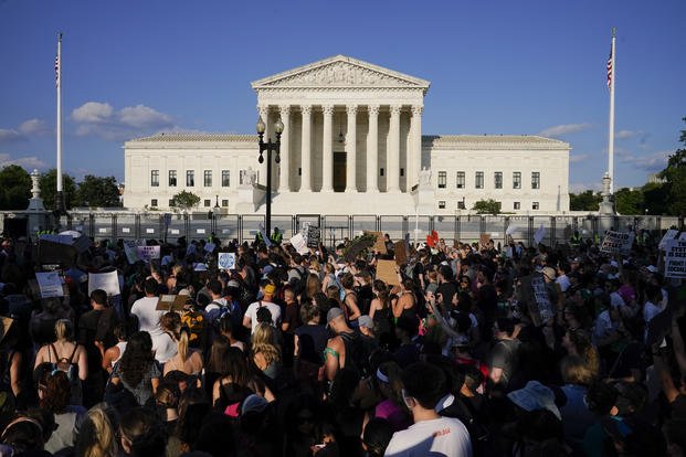 Protesters fill the street in front of the Supreme Court.