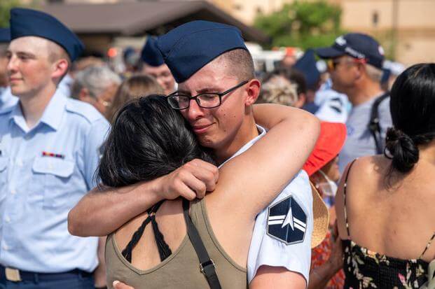 A graduate of Space Force basic military training embraces a loved one.