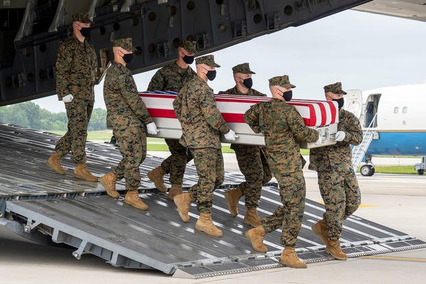 A U.S. Marine Corps carry team transfers the remains of Marine Corps Lance Cpl. Jared M. Schmitz of St. Charles, Missouri, Aug. 29, 2021 at Dover Air Force Base, Delaware.