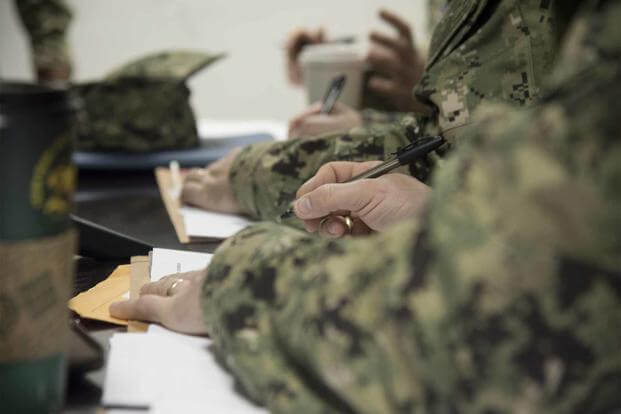 U.S. Navy sailors fill out paperwork at Camp Lemonnier, Djibouti.