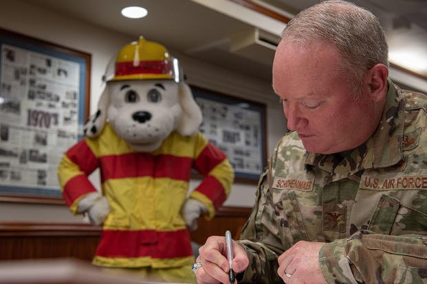 U.S. Air Force Col. Ronald D. Schochenmaier, 18th Wing vice commander, signs the 2022 Fire Prevention Proclamation at Kadena Air Base, Japan.