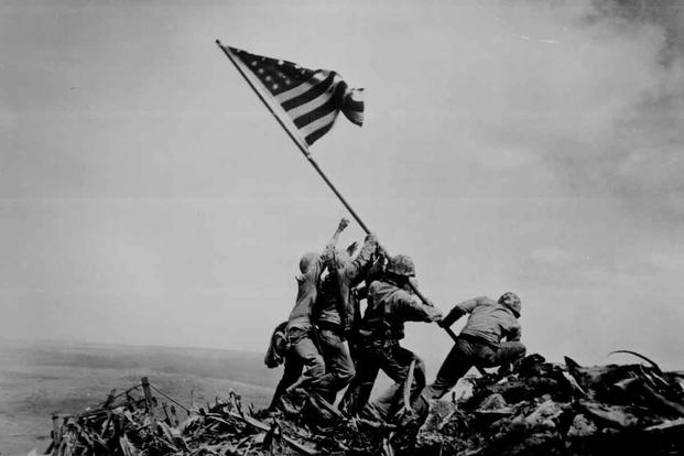Marines raise the American flag on Mount Suribachi.