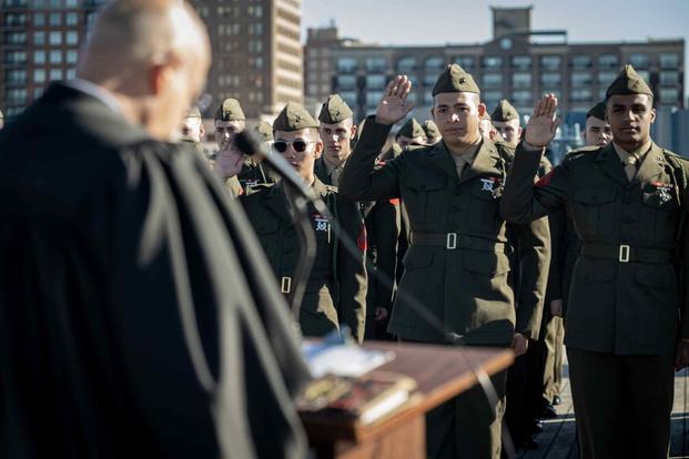 U.S. Marines raise hands during the Oath of Allegiance.