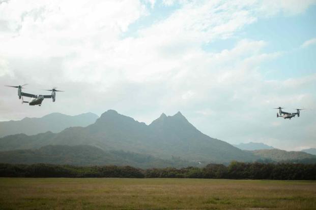 Two MV-22 Ospreys fly in formation over a training area in Hawaii.