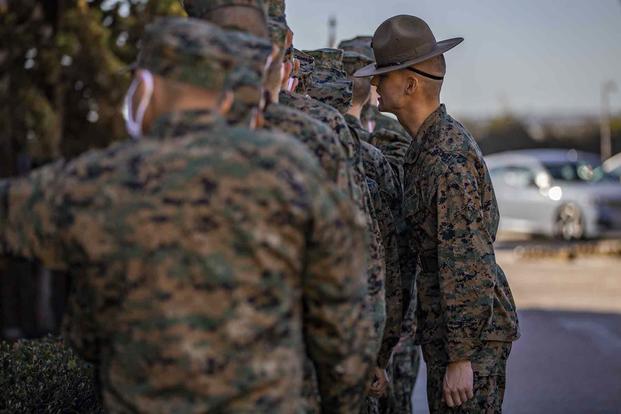 A Marine drill instructor “corrects” a recruit.