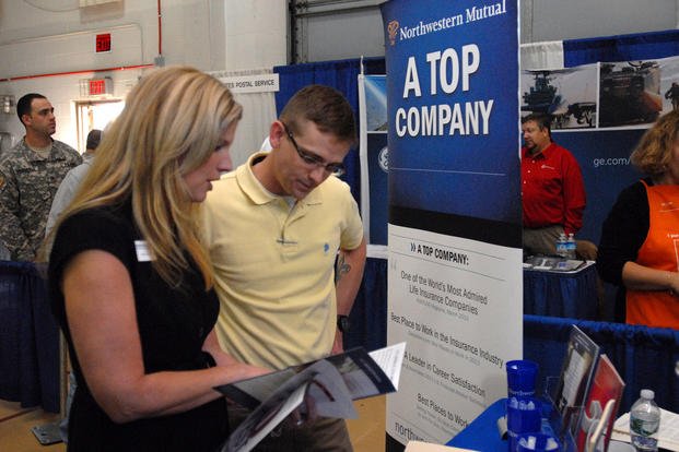 A representative from Northwestern Mutual Financial Network speaks with a New York Army National Guard soldier at the U.S. Chamber of Commerce’s ‘Hiring Our Heroes’ job fair.