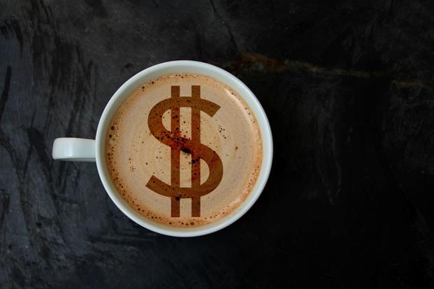 A dollar sign appears in the foam of a latte