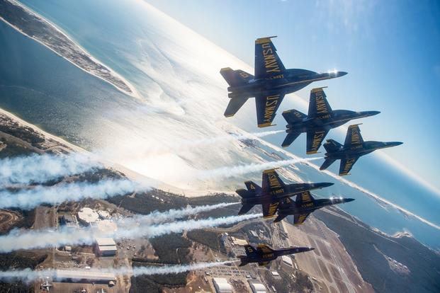 The U.S. Navy Flight Demonstration Squadron, the Blue Angels, perform the Delta Roll maneuver during a training flight over Naval Air Station (NAS) Pensacola. 