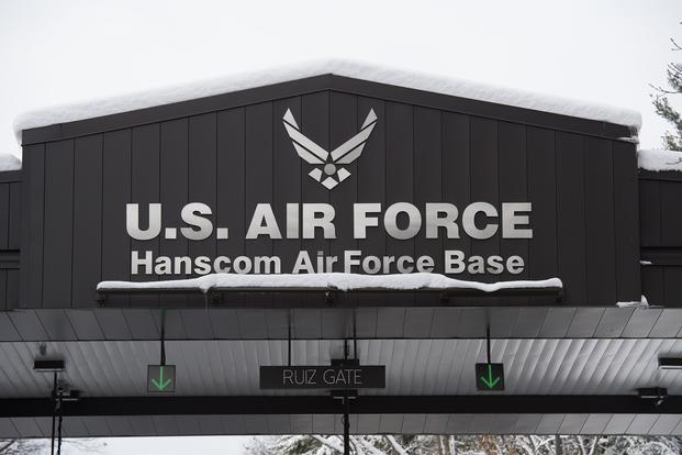 Members of the workforce enter the Ruiz Gate at Hanscom Air Force Base, Mass., Dec. 4. 