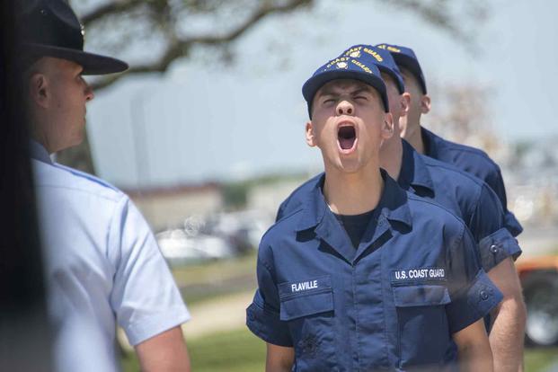 Coast Guard boot camp recruits shout a response